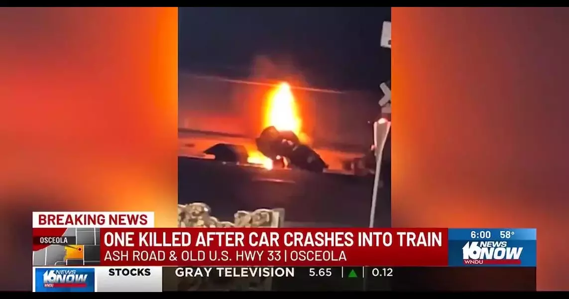 Person killed after fiery car crash into train