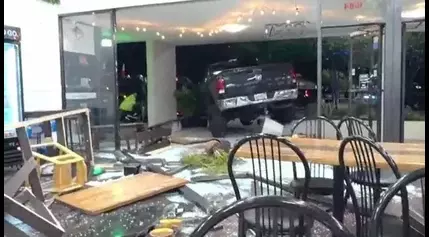 VIDEO: Truck slams into Florida bakery, crashes into parked car