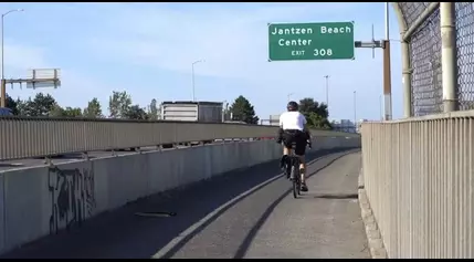 Car driver speeds onto bike path adjacent to I-5