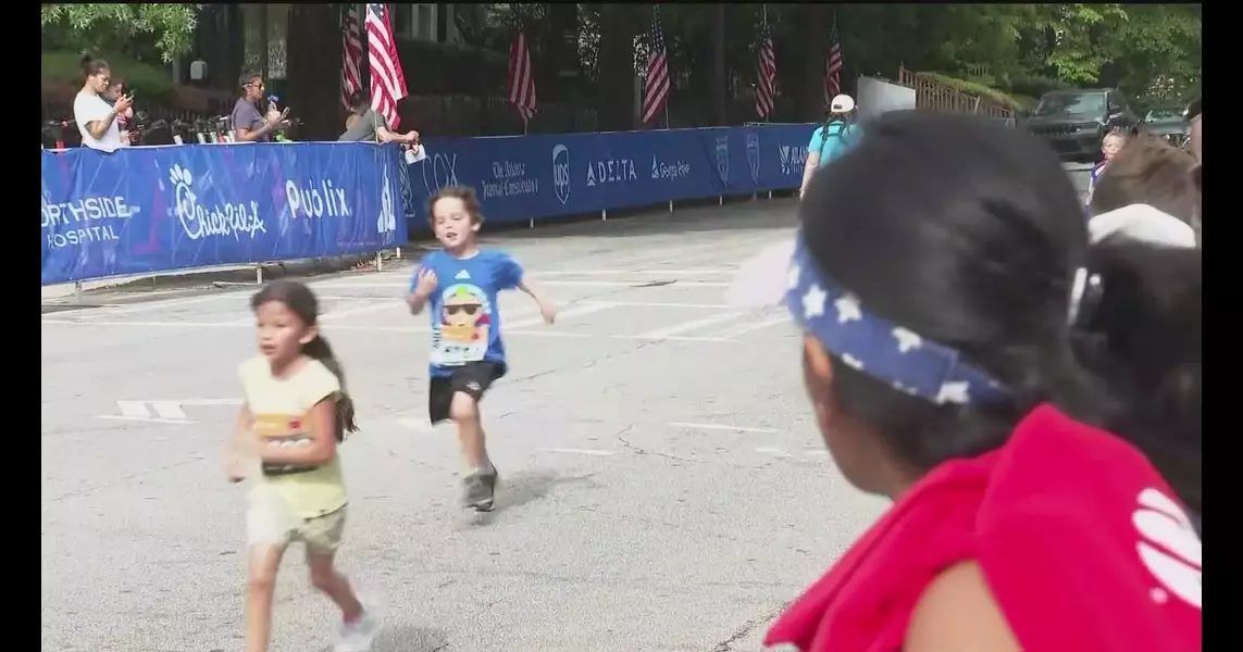 Hundreds of kids go for a fun run through Piedmont Park