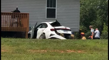 Car crashes into power pole, house in Lexington