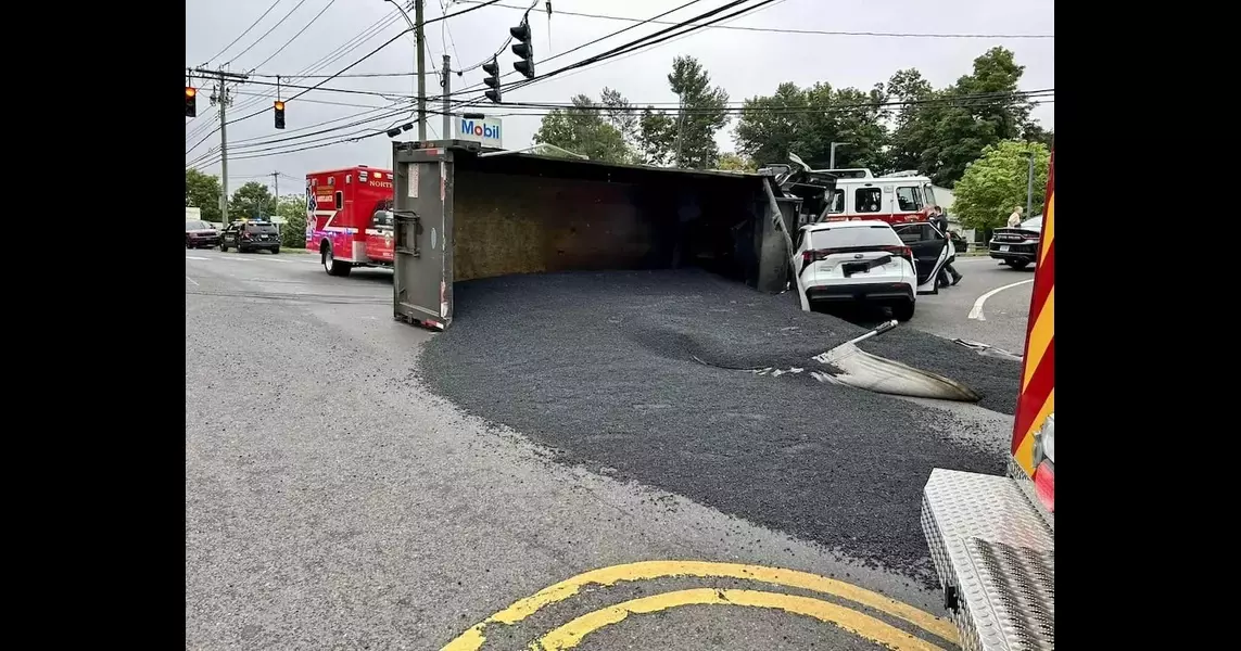 Dump truck rolls onto car in North Branford