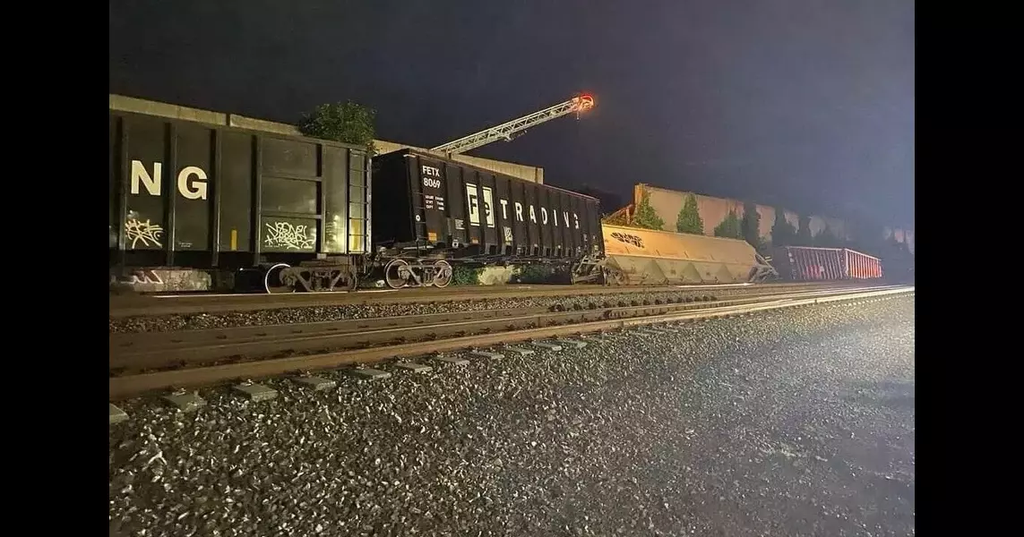 Freight train cars derail, striking wall that collapsed garage buildings in Fredericksburg, Va.