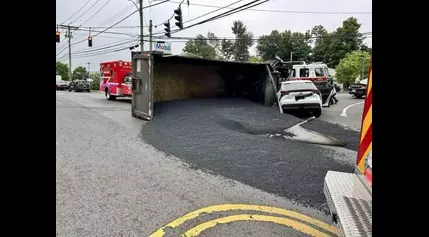 Dump truck rolls onto car in North Branford