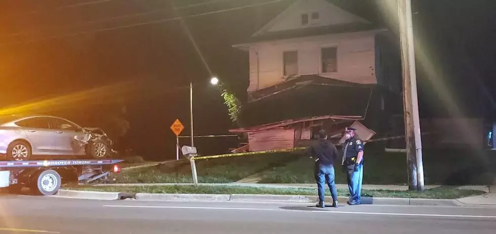 One person injured after car crashes into home in Lansing