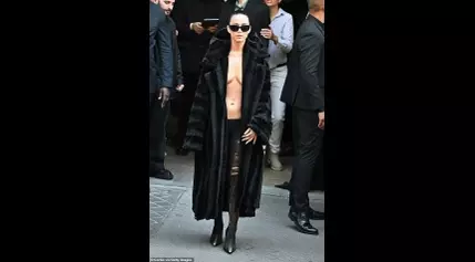 Katy Perry goes braless in a perilously plunging fur jacket