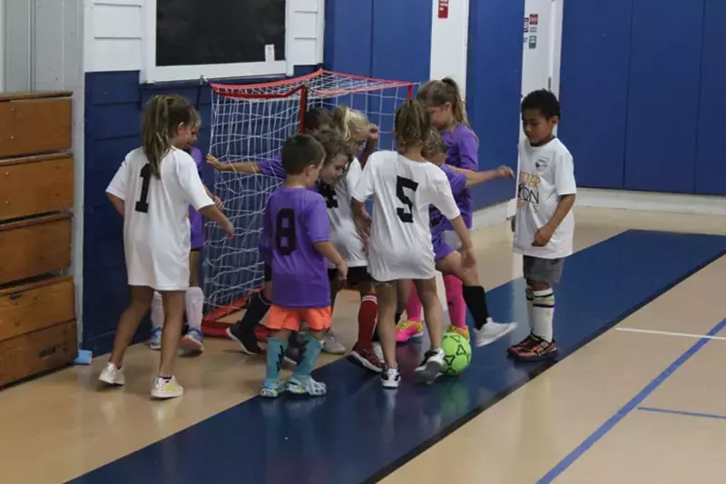 Kids take soccer indoors, adult football on the outdoor field