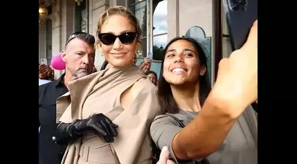 Jennifer Lopez Beams While Posing for Pics at Paris Fashion Week