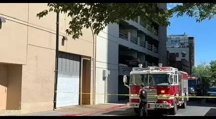 Driver Hospitalized After Hitting Parked Car in Parking Garage, Sending it Dangling Over Ledge