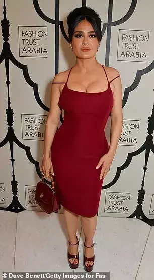 Salma Hayek, 57, puts on a very busty display in a plunging red dress