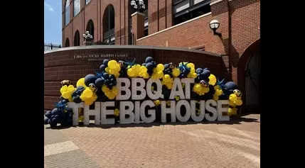 LOOK: Michigan “smokes out haters” with food at BBQ at the Big House