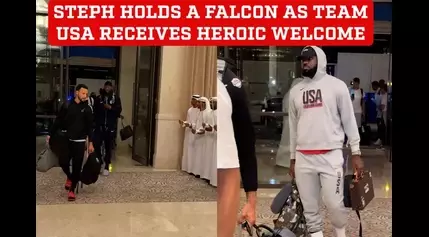 Steph Curry is given a live falcon to hold as USA Olympics basketball stars are greeted by a guard of honor