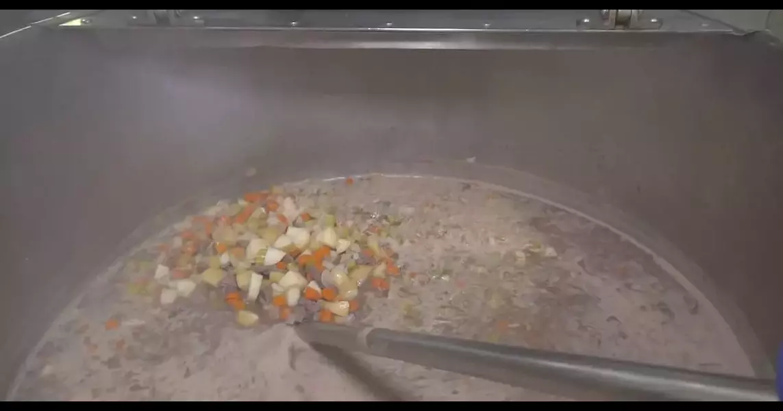 Bedford volunteers prep cans of venison stew to fight food insecurity