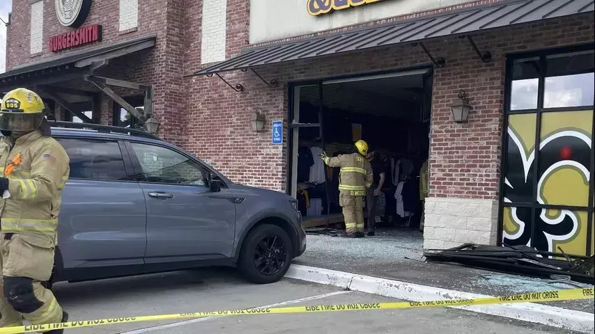 Car runs into Siegen Lane storefront; one person taken to hospital