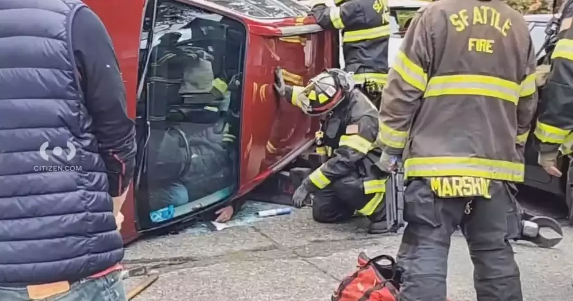 Fire crews pull driver from flipped car in Ballard