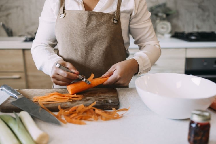 Woman peeling carrots