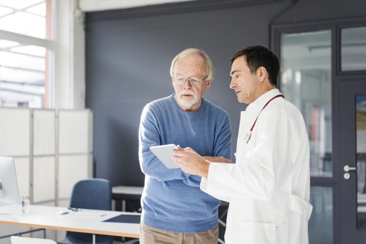 Older man talking to doctor
