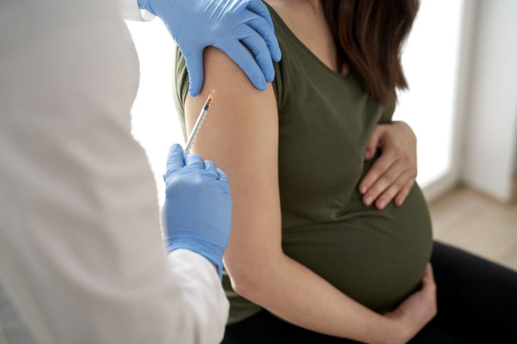 Pregnant woman getting a shot