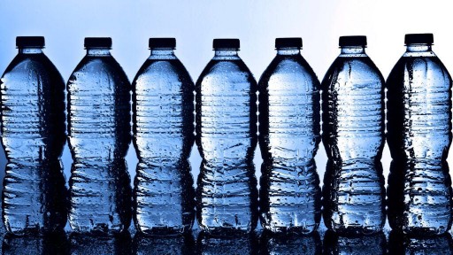 Plastic bottles of water lined up on a table