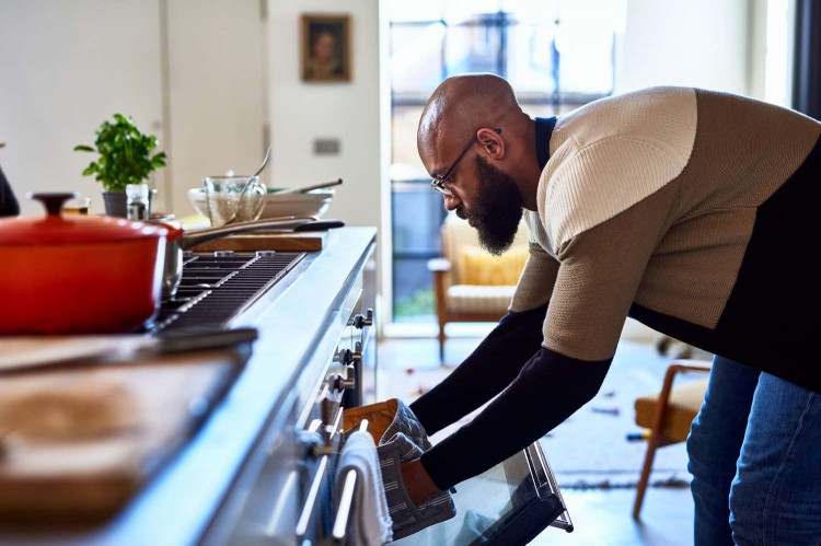 Man taking something out of the oven
